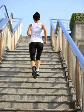 busy schedule workout woman running up stairs