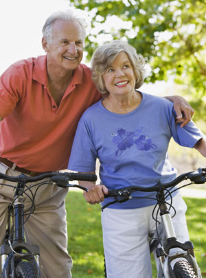 healthy aging couple on bicycles