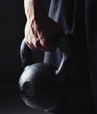 kettlebell exercises for beginners man holding kettlebell